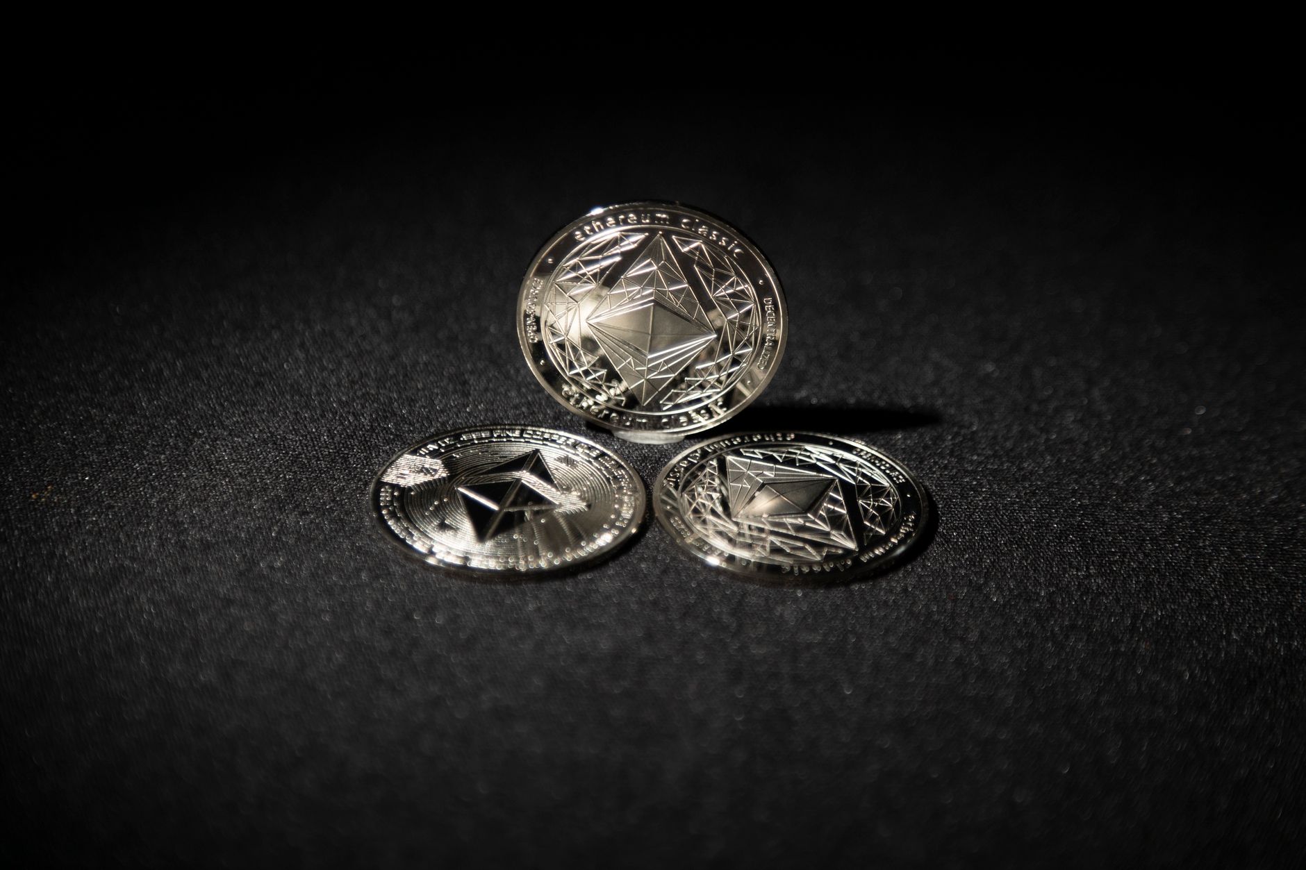 A handful of brass arcade tokens on a counter