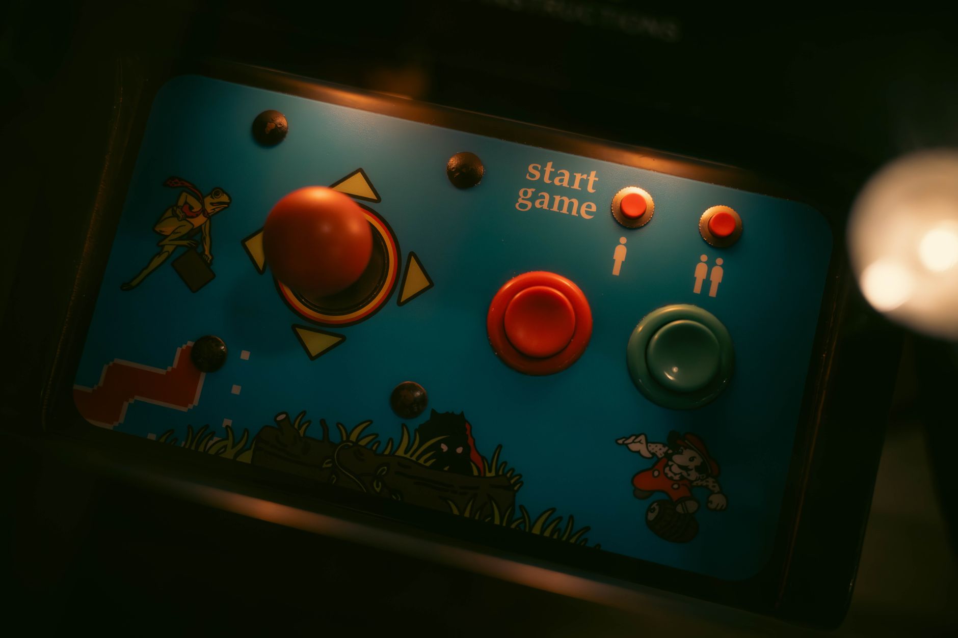 Lit control panel of a retro arcade cabinet